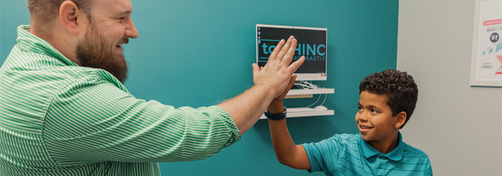 Chiropractor Greenville SC Zane Gray With Child Patient Chiropractor Greenville SC Zane Gray With Child Patient